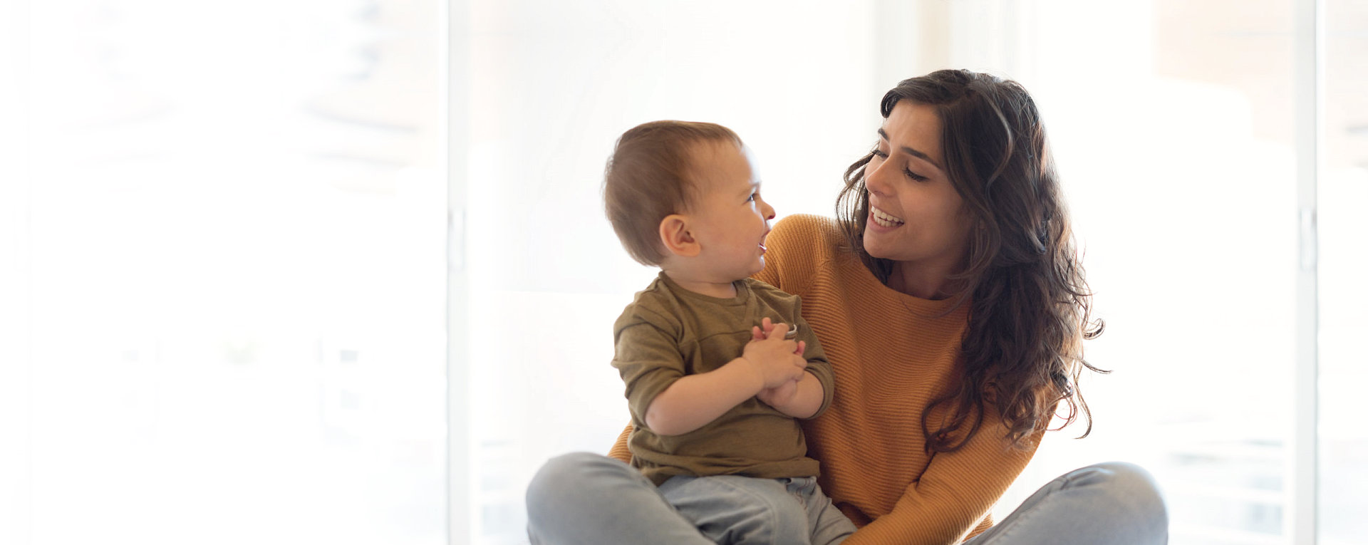 a mother and a baby looking at each other