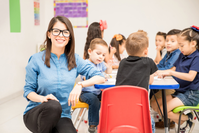 Portrait of preschool teacher having class