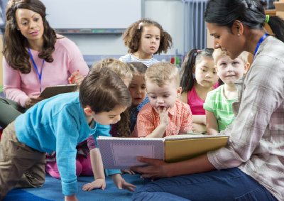 teacher giving a lesson to nursery students